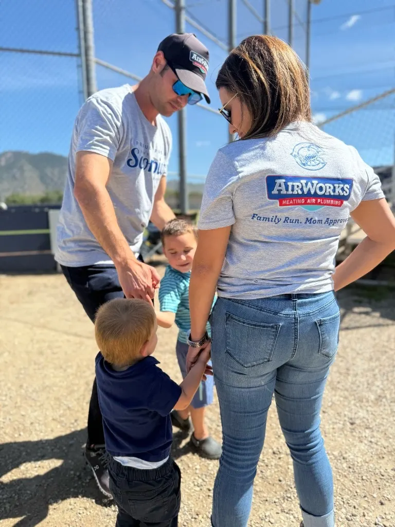 Kevin, Stephanie, and their children wearing AirWorks shirts at a community event